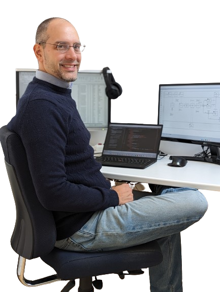 Profile Picture of Olivier Roger (@oroger), sitting on a desk, while looking at a the camera